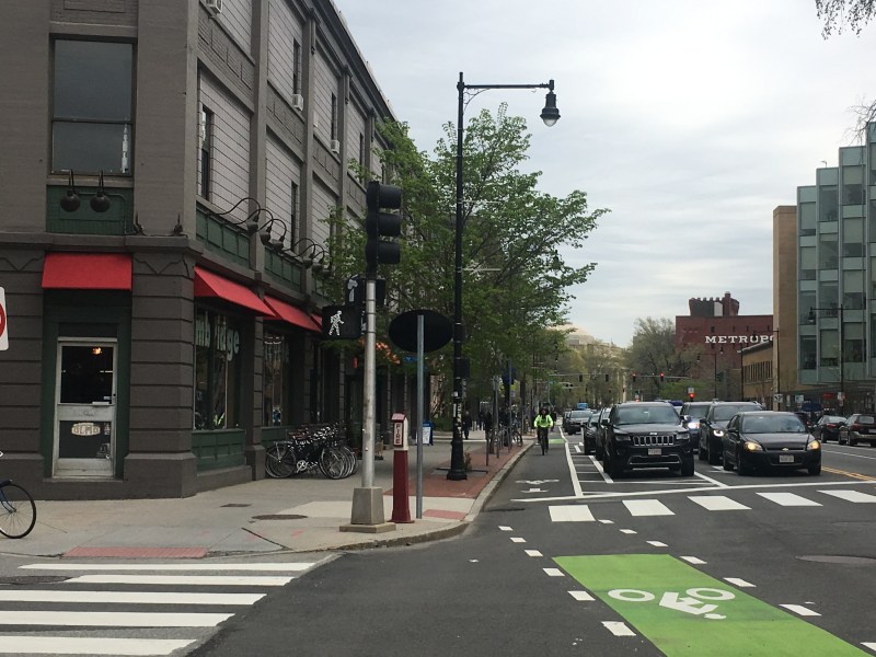 The Massachusetts Avenue protected bike lane near Front Street and the Cambridge Bicycle shop, pictured in May 2019.