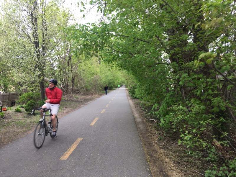 A person rides a bike along the Minuteman path in East Arlington.