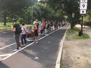 During the morning rush hour on July 11, 2019, dozens of safety advocates gathered to create a "people-protected" barrier for the painted bike lanes on Park Drive in Boston's Fenway neighborhood.