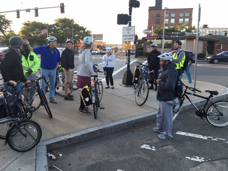 A group of bicycle users discuss the section of Massachusetts Avenue near the Newmarket MBTA station with City of Boston transportation planners during a group ride on Sept. 18, 2019.