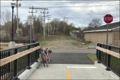 The future downtown segment of the Columbia Greenway rail trail in Westfield, seen from an existing bike and pedestrian bridge in the city's riverfront park. A project currently under construction will extend the trail half a mile  through the heart of downtown Westfield. Courtesy of the Friends of the Columbia Greenway.