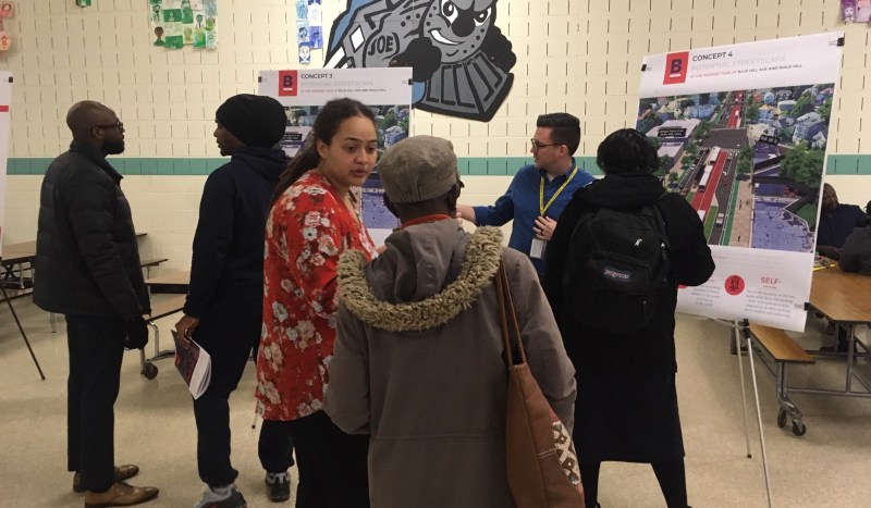 City of Boston planner Lindiwe Rennert (center) discusses the city's plans to set aside dedicated bus lanes for Blue Hill Avenue, home to the state's busiest bus route, at a project open house on Thursday, March 5, 2020.