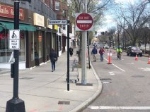 Pedestrians take advantage of expanded walking areas on Beacon Street in Brookline in mid-April. Brookline officials have repurposed on-street parking areas to provide additional space for safe physical distancing in commercial districts and on key routes to area hospitals; City of Boston officials may soon follow suit. Photo courtesy of the Brookline Transportation Department.
