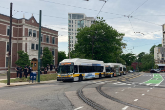MBTA buses carrying police wait near the Heath Street Green Line stop on the evening of Thursday, June 4, as peaceful protesters gathered nearby. Photo courtesy of Jessica Feldish.