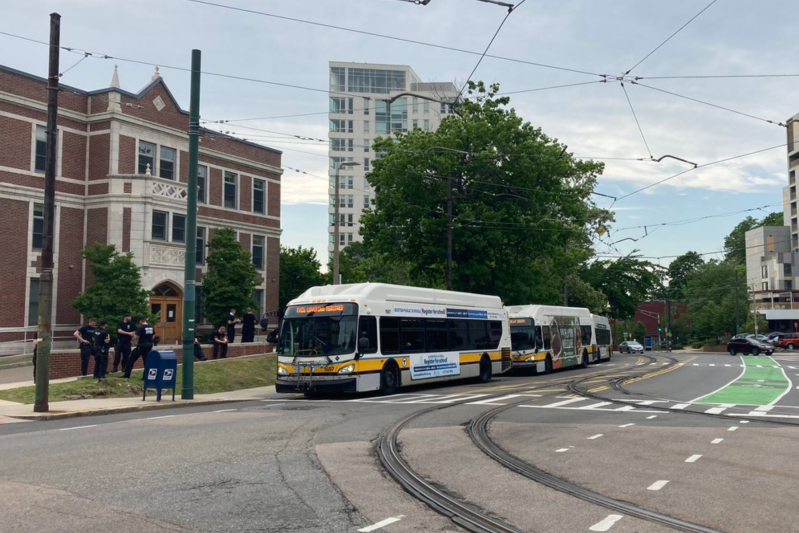 MBTA buses carrying police wait near the Heath Street Green Line stop on the evening of Thursday, June 4, as peaceful protesters gathered nearby. Photo courtesy of Jessica Feldish.