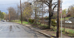 Washington Street in Newton, which runs along the Worcester commuter rail line and Massachusetts Turnpike embankment, currently lacks sidewalks and crosswalks to bus stops like this one. Courtesy of the City of Newton.