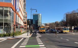 New development, new sidewalks, and new protected bike lanes line Washington Street in Brookline Village. The town is moving forward with a proposal to set aside one lane in each direction on the newly-reconstructed street as dedicated bus lanes for the MBTA's route 60, 65, and 66 buses.