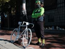 Peter Cheung with a ghost bike memorial to Darryl Willis, who was killed in Harvard Square in August 2020.