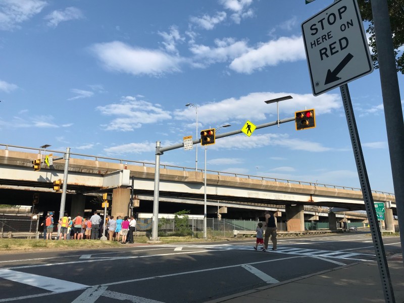The crosswalk at the Kensington Underpass (at left) across Mystic Avenue. Drivers on Mystic Avenue frequently ignore the flashing red lights above the crosswalk.