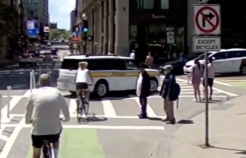 Screenshot of a video showing an MBTA The RIDE driver making an illegal turn and driving on the Boylston Street bike path