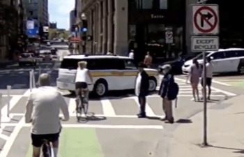 Screenshot of a video showing an MBTA The RIDE driver making an illegal turn and driving on the Boylston Street bike path