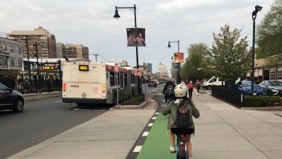 Bike traffic on the Commonwealth Avenue protected bike lane next to the MBTA's Babcock Street Green Line station.