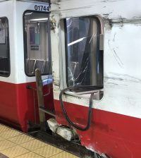 Damage from the Sept. 28 Red Line derailment at Broadway station (note the chunk of concrete platform attached to the train). Photo by Elisabeth Boyce-Jacino, used with the photographer's permission.