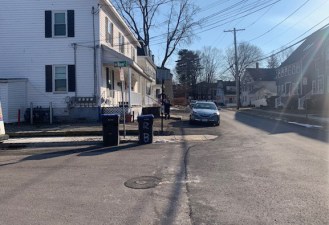 School Street in Natick, showing a car parked on the town's new asphalt sidewalk.
