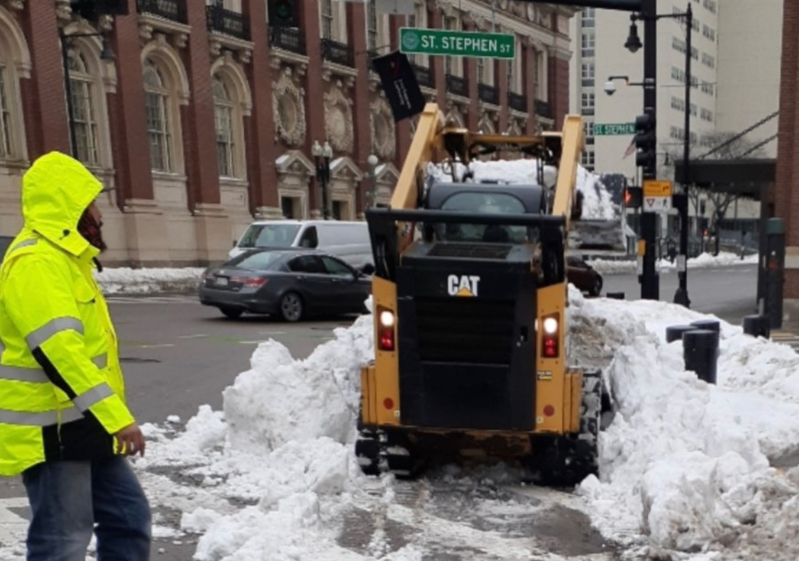 City of Boston Public Works Department workers clear snowbanks from a crosswalk outside of Symphony Hall in the aftermath of the blizzard of January 30, 2022.