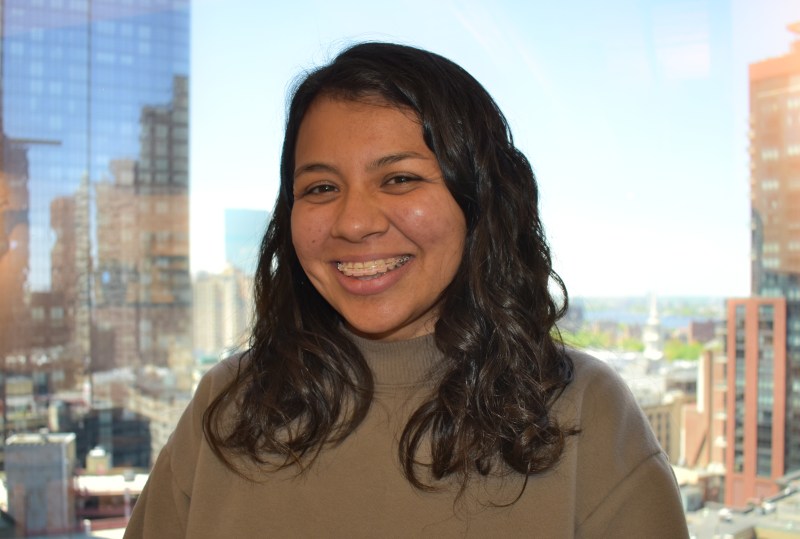 Portrait of Grecia White in front of the downtown Boston skyline