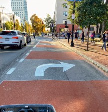 red paint and white arrows along the new bus and bike lane